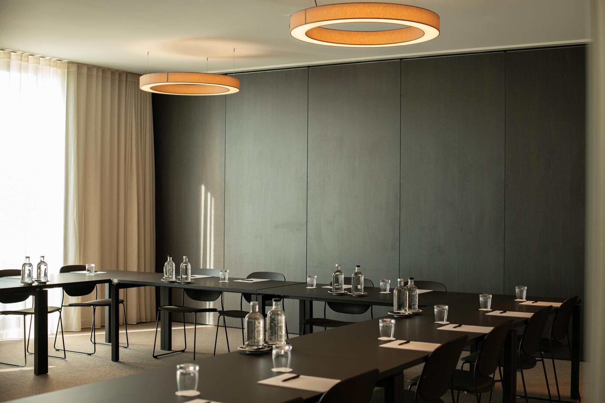 Meeting room at Hotel De Blanke Top with a long table and water bottles.